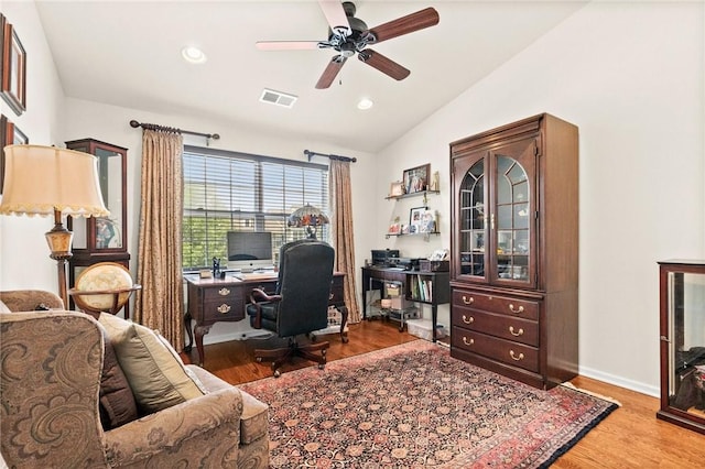 home office featuring ceiling fan, vaulted ceiling, and light hardwood / wood-style flooring