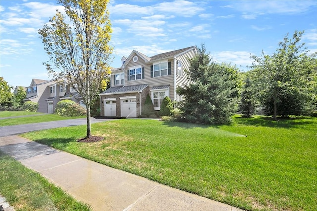 view of front of property featuring a front yard and a garage