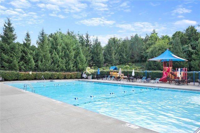 view of swimming pool with a playground