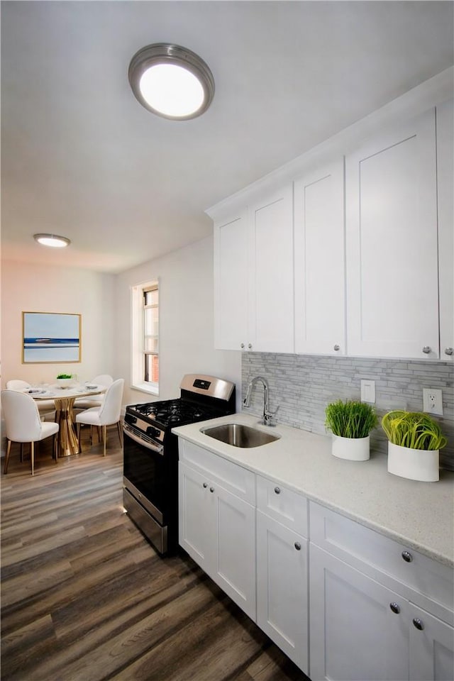 kitchen with white cabinetry, sink, dark wood-type flooring, tasteful backsplash, and stainless steel range with gas stovetop