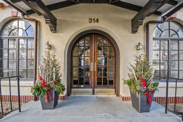 view of exterior entry featuring french doors