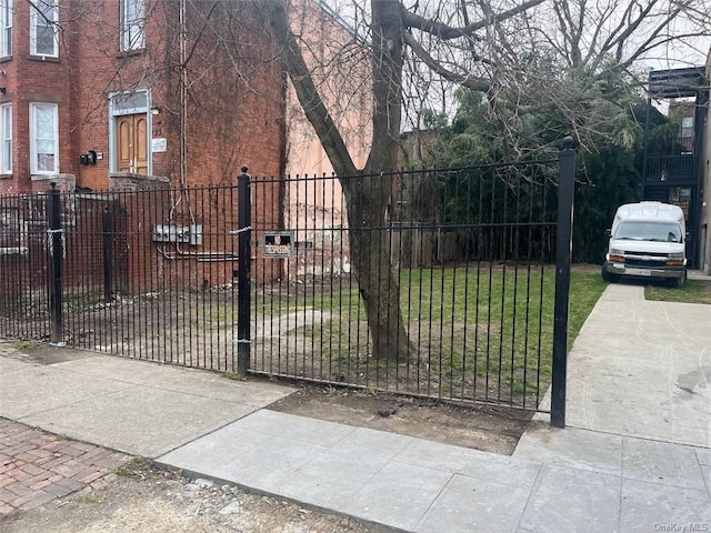 view of gate featuring a lawn