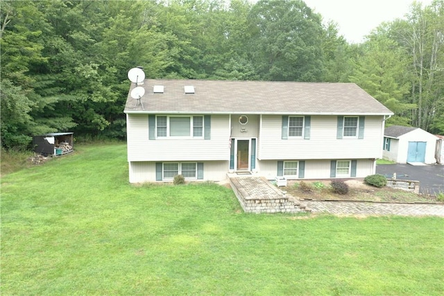 raised ranch with a shed and a front yard