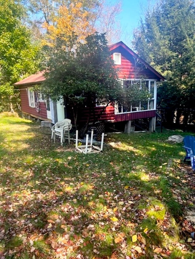 rear view of house featuring a lawn