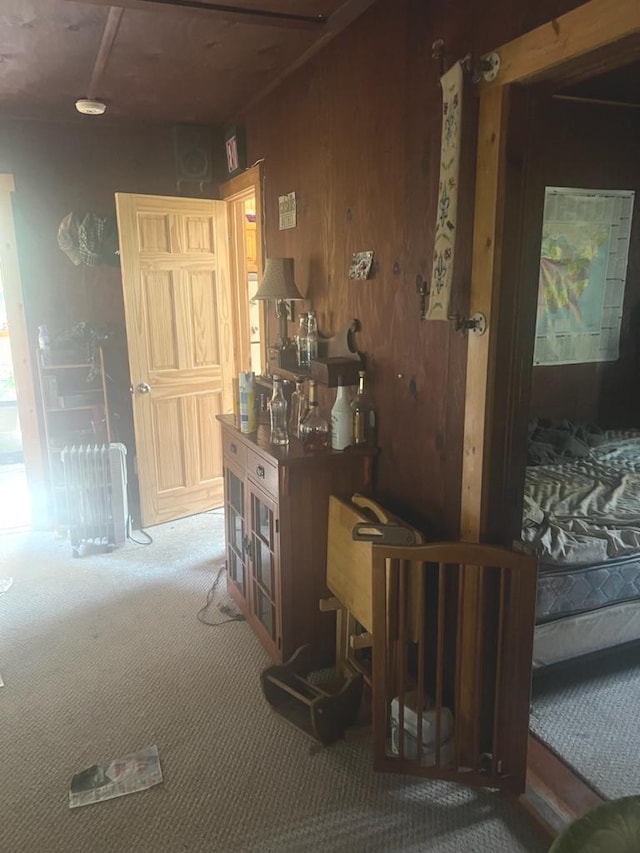 interior space featuring carpet floors and wooden walls