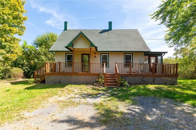 view of front of house with covered porch and a front lawn