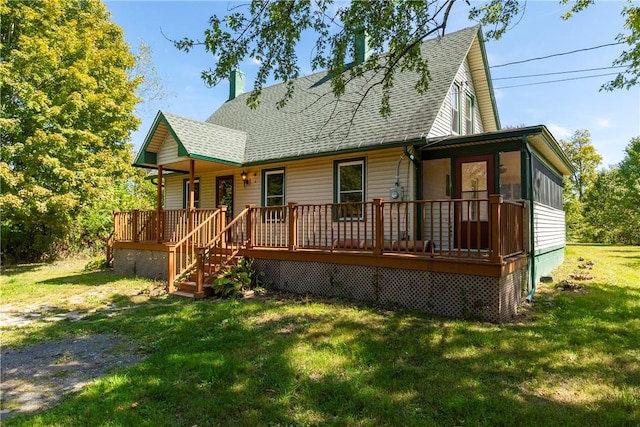 rear view of property with a lawn