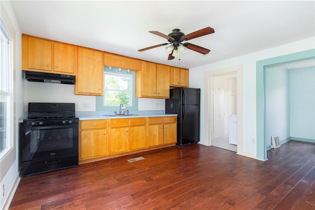 kitchen with black appliances, dark hardwood / wood-style floors, ceiling fan, and sink