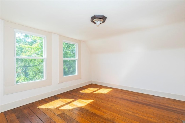 bonus room with hardwood / wood-style floors and lofted ceiling