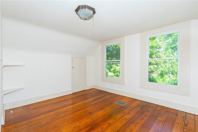 additional living space featuring hardwood / wood-style flooring and vaulted ceiling