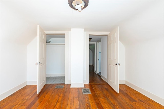 unfurnished bedroom featuring dark wood-type flooring and a closet