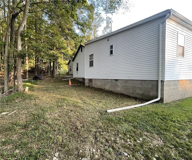 view of side of home with a lawn