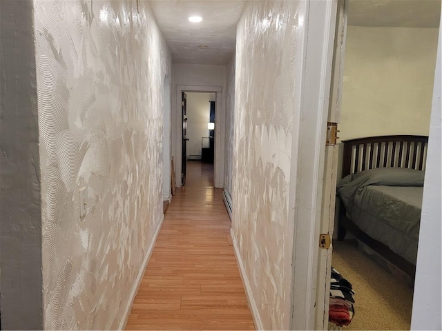 corridor with light hardwood / wood-style flooring