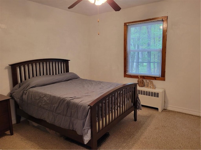 bedroom featuring light carpet, radiator heating unit, and ceiling fan