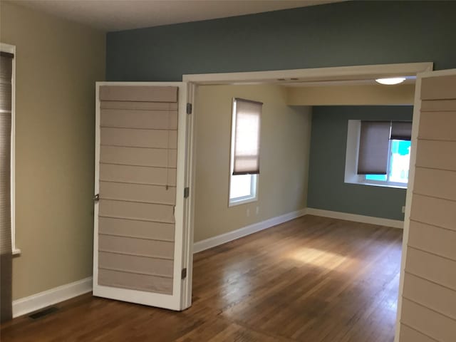 empty room featuring dark hardwood / wood-style flooring