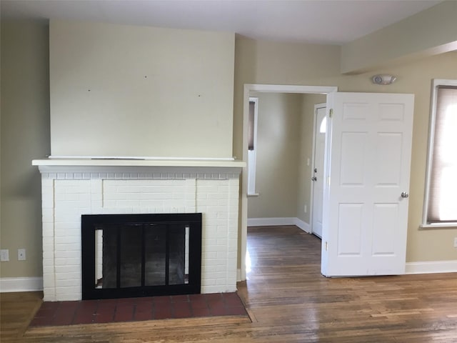 room details with hardwood / wood-style floors and a brick fireplace