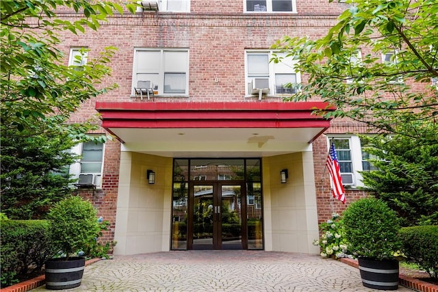 entrance to property featuring cooling unit and french doors