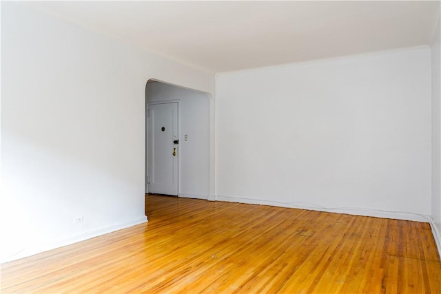 empty room with hardwood / wood-style flooring