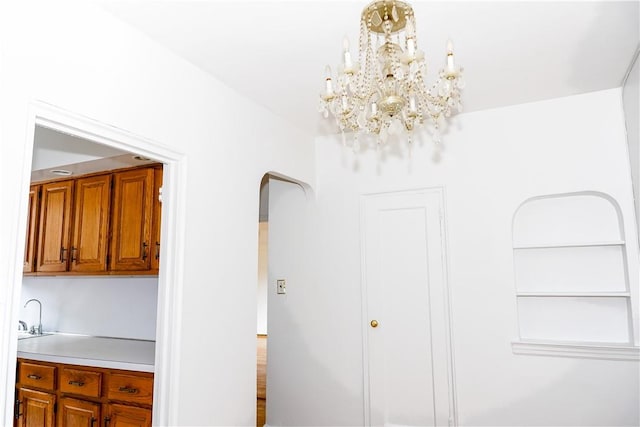 interior space featuring sink and a notable chandelier