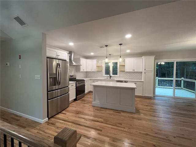 kitchen with sink, white cabinets, pendant lighting, and appliances with stainless steel finishes