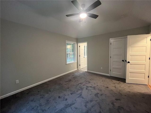 unfurnished bedroom featuring ceiling fan and carpet floors