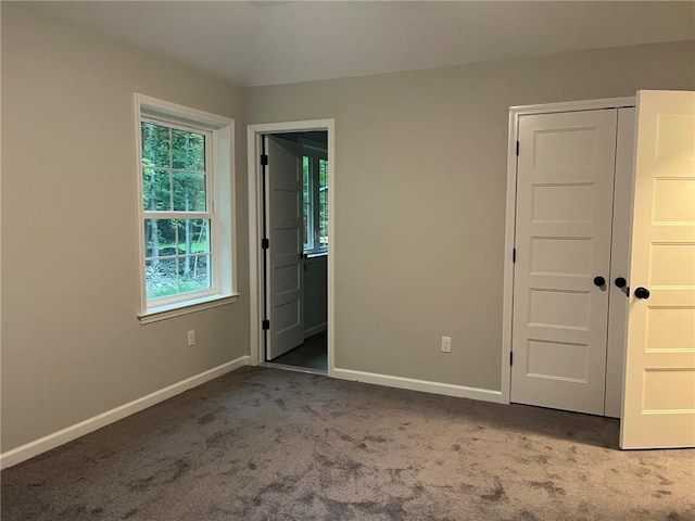 unfurnished bedroom with a closet and carpet floors