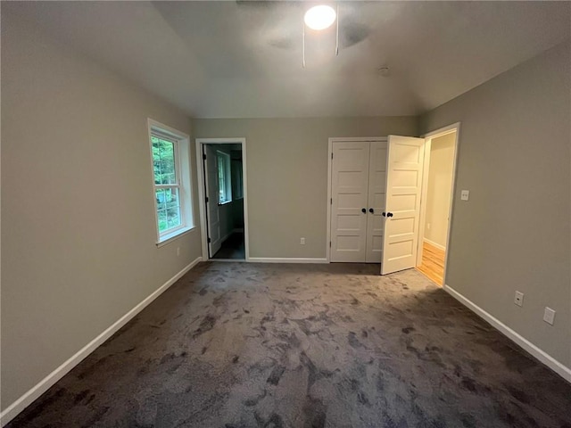 unfurnished bedroom featuring carpet floors and ceiling fan