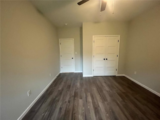 unfurnished bedroom featuring ceiling fan, dark hardwood / wood-style flooring, and a closet