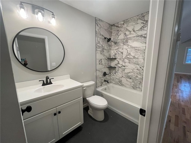 full bathroom featuring vanity, hardwood / wood-style floors, tiled shower / bath combo, and toilet