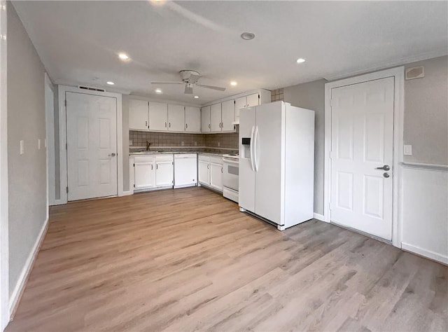kitchen with white cabinets, light wood-type flooring, white appliances, and backsplash