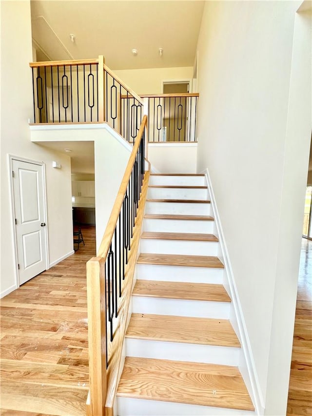 stairway with hardwood / wood-style flooring