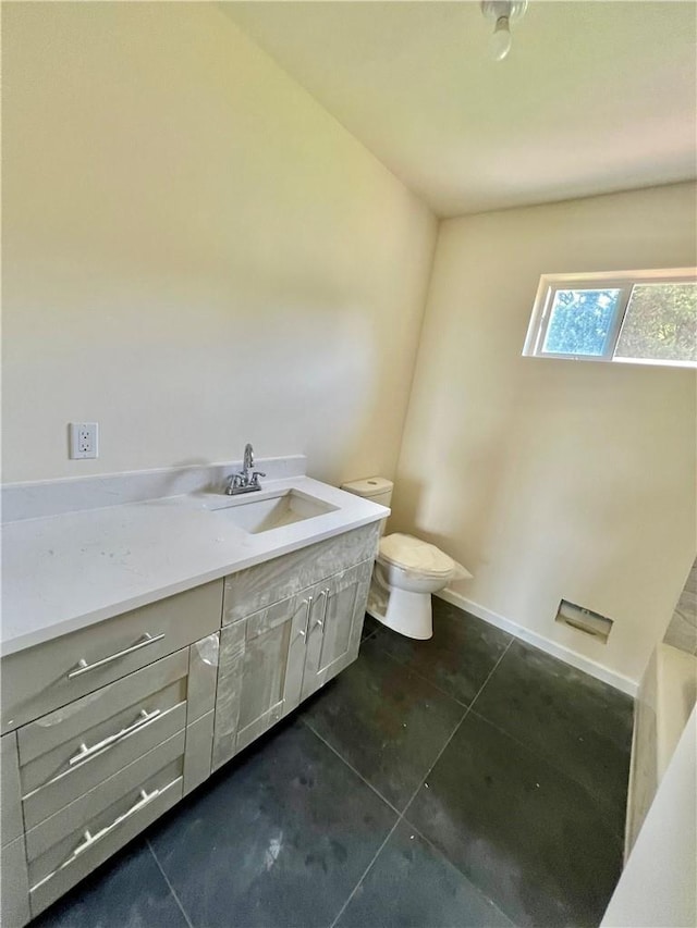 bathroom featuring tile patterned floors, vanity, and toilet