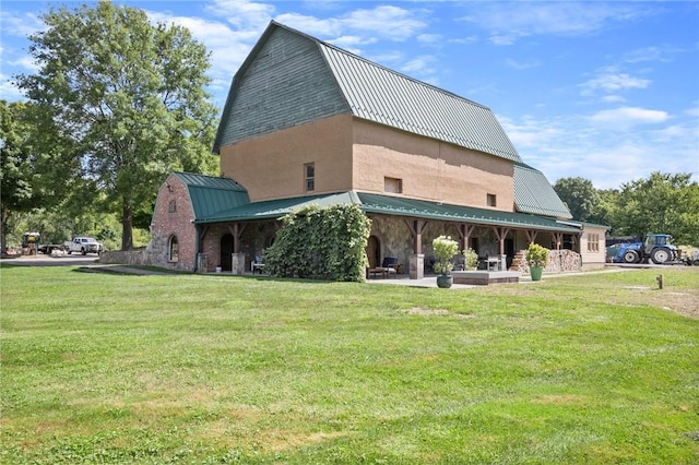 rear view of house with a yard