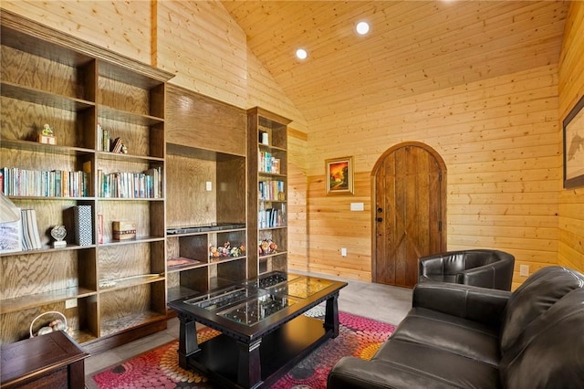 living area with carpet floors, high vaulted ceiling, wooden ceiling, and wood walls