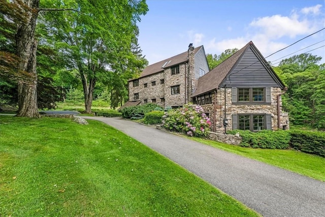 view of property exterior featuring a lawn