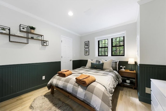 bedroom with light hardwood / wood-style flooring and ornamental molding