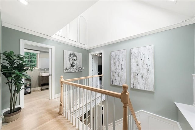 hall featuring light hardwood / wood-style floors and ornamental molding