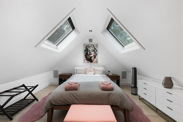 bedroom with vaulted ceiling with skylight