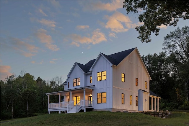 view of front of home featuring covered porch and a yard