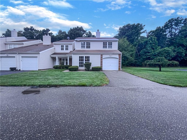 view of front property featuring a garage and a front yard