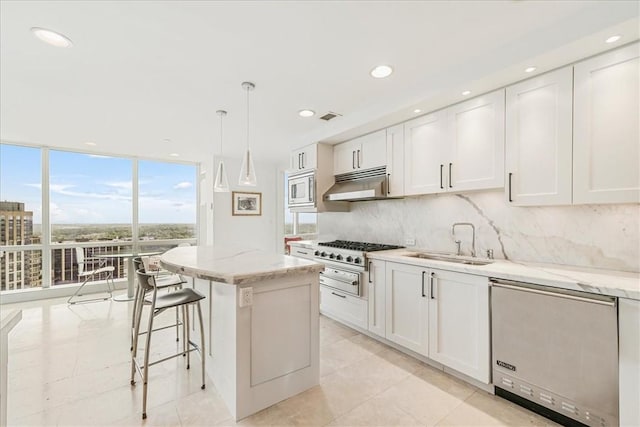 1 Renaissance Sq Unit Ph2Bc, White Plains, NY 10601 - kitchen featuring a sink, under cabinet range hood, backsplash, a center island, and white cabinetry