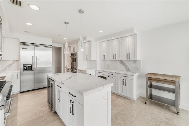 kitchen with white cabinets, a kitchen island, and stainless steel appliances