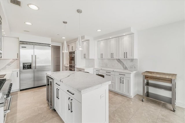 1 Renaissance Sq Unit Ph2Bc, White Plains, NY 10601 - kitchen with high quality appliances, beverage cooler, decorative backsplash, recessed lighting, and a center island
