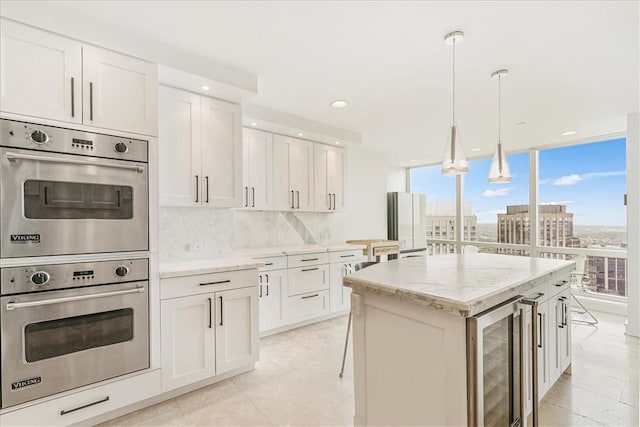 1 Renaissance Sq Unit Ph2Bc, White Plains, NY 10601 - kitchen featuring double oven, beverage cooler, tasteful backsplash, light stone countertops, and white cabinets