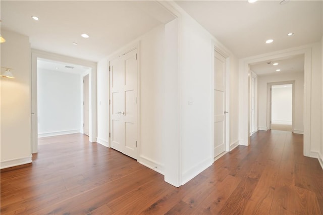 hall with dark wood-type flooring