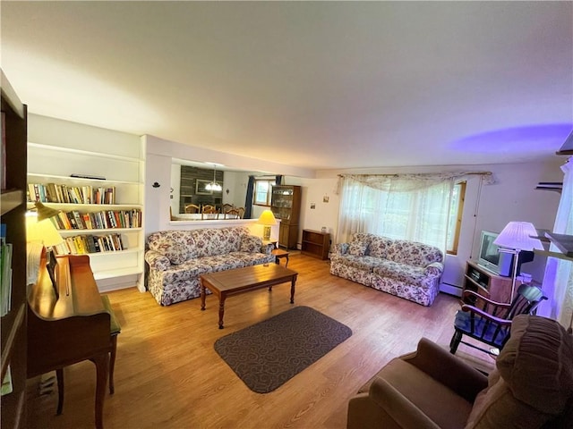 living room with light hardwood / wood-style floors and baseboard heating