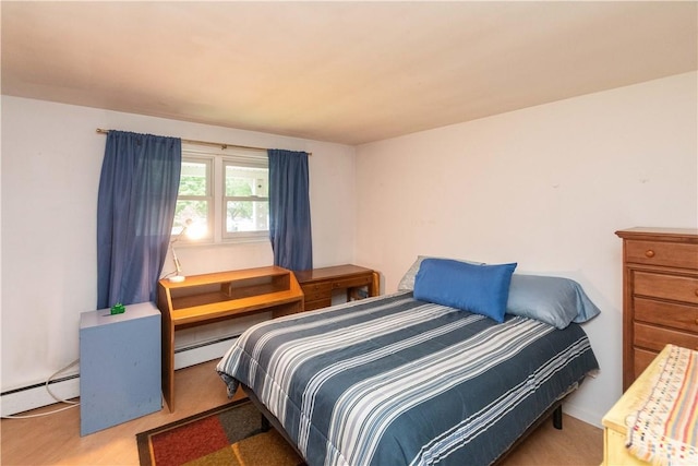 carpeted bedroom featuring a baseboard heating unit