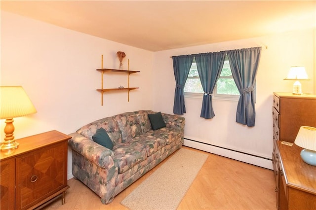 living room with a baseboard radiator and light hardwood / wood-style floors