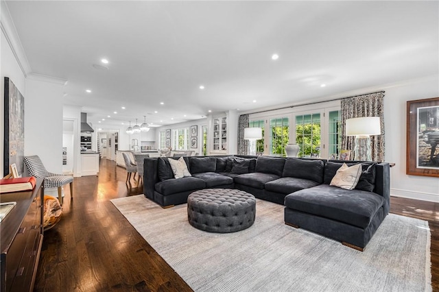 living room featuring hardwood / wood-style flooring, plenty of natural light, and ornamental molding