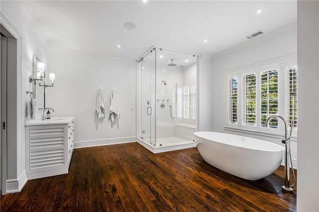 bathroom with hardwood / wood-style floors, vanity, shower with separate bathtub, and ornamental molding